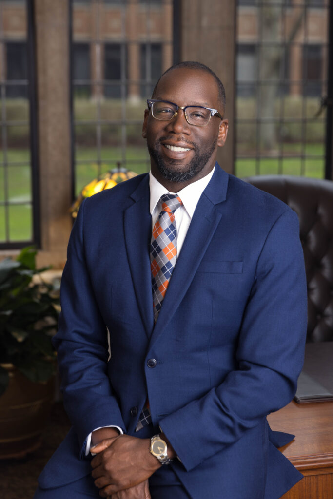 Headshot of black man in office wearing suit