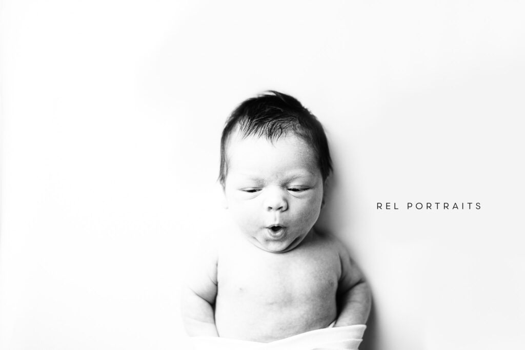Newborn making kissy face by skokie photographer