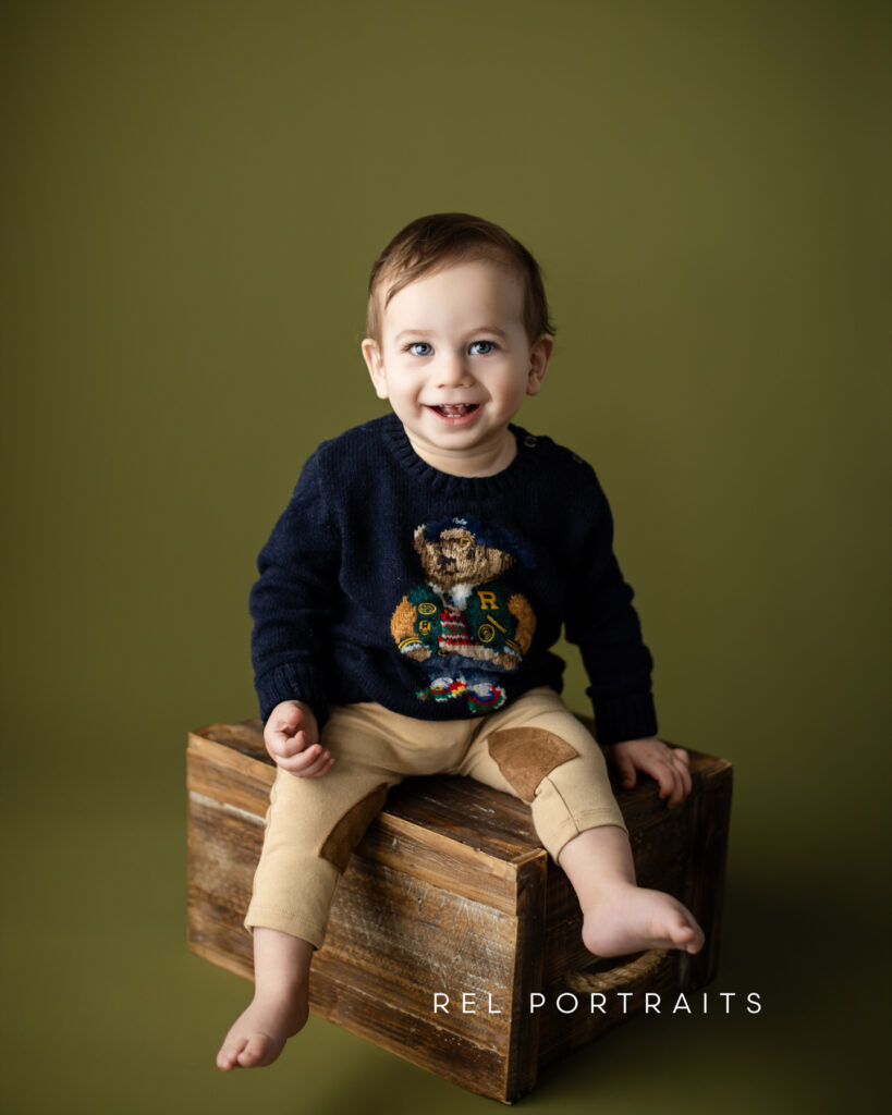 Baby boy sitting on box for Milestone Session