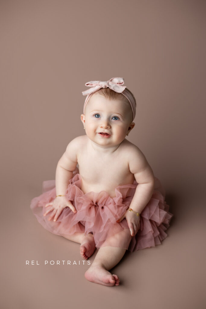 Smiling baby girl 9 months photo pink