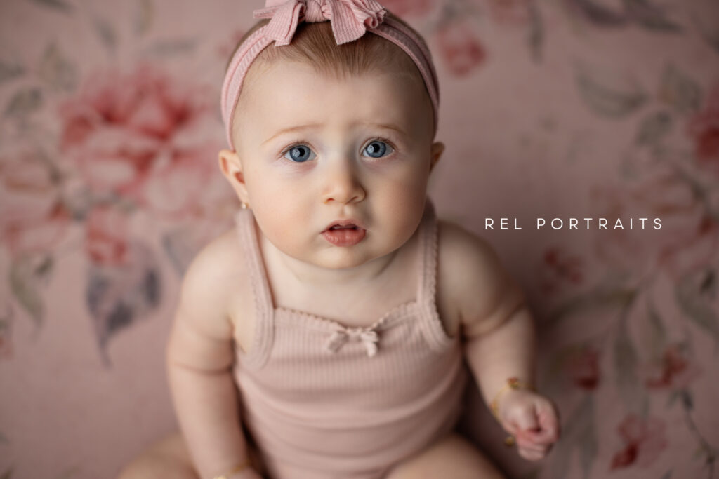 sitter session milestone photo baby girl in pink