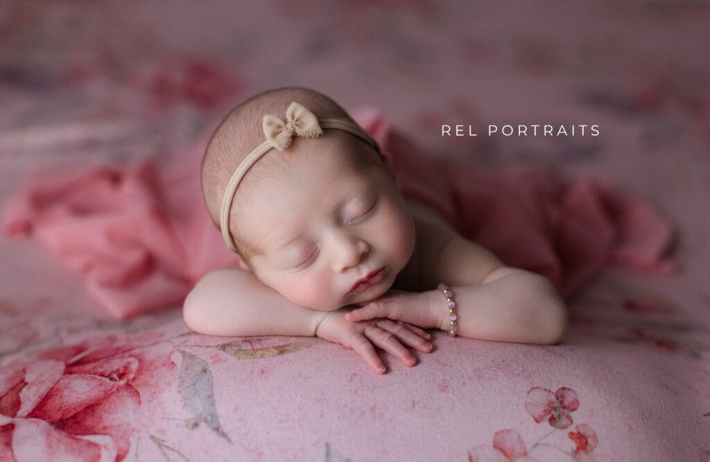 baby girl chin on hands floral pink