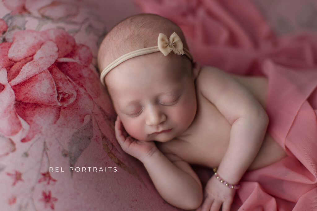 newborn baby girl on floral backdrop