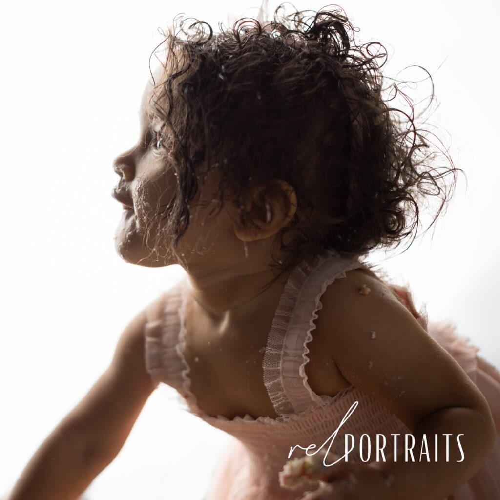 Baby Girl Messy with cake on white backdrop