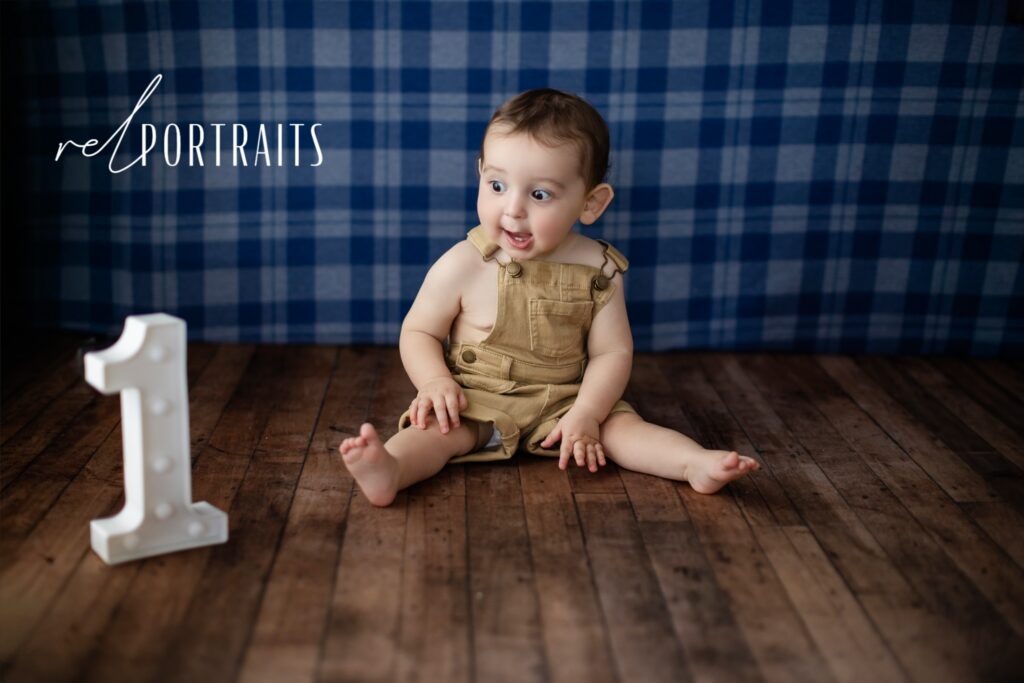baby boy on plaid background one year old 