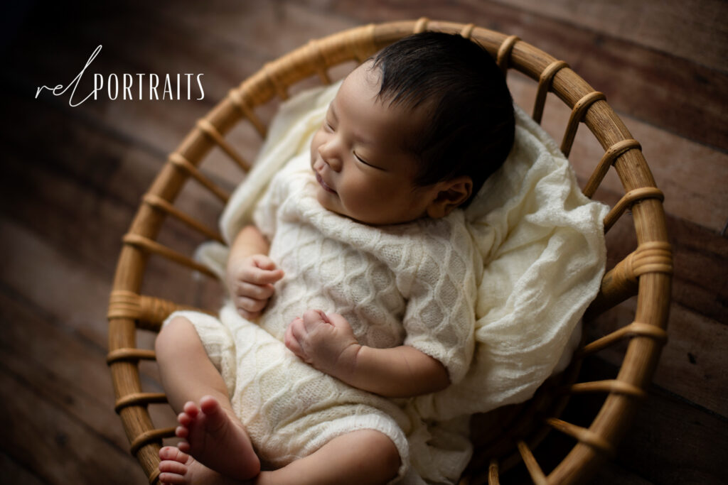 baby boy in basket sleeping