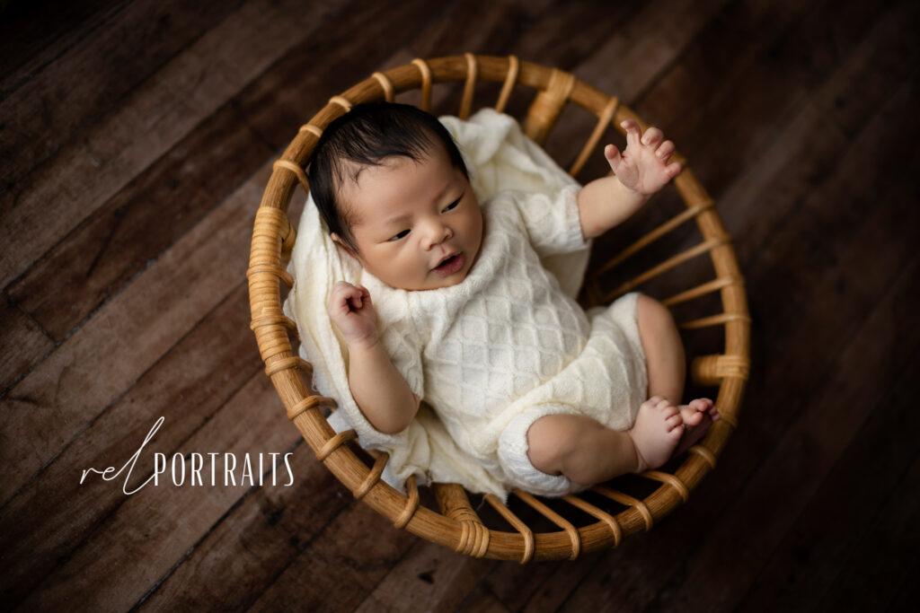 baby boy in basket at photoshoot