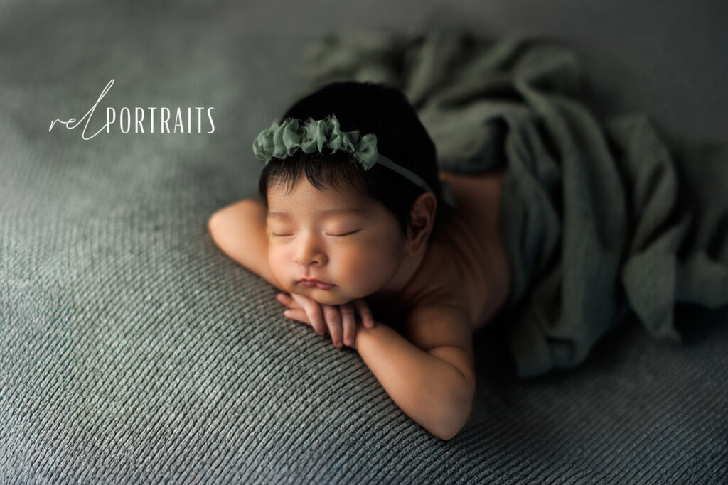 Newborn Baby Girl sleeping in green