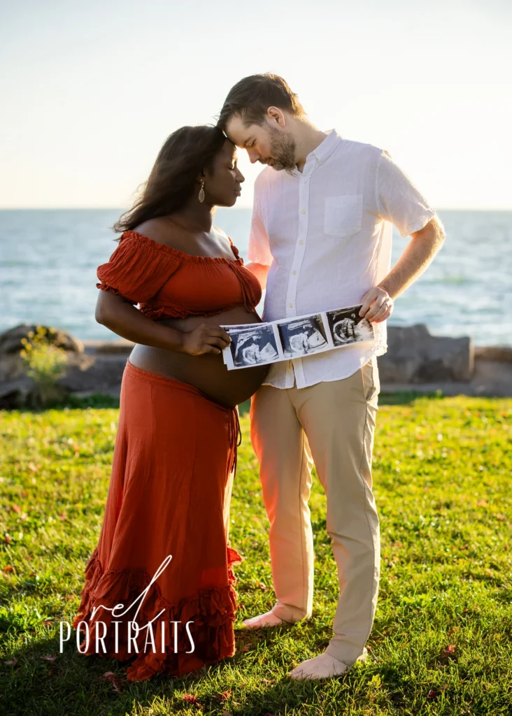 biracial couple with mom pregnant and ultrasound photo