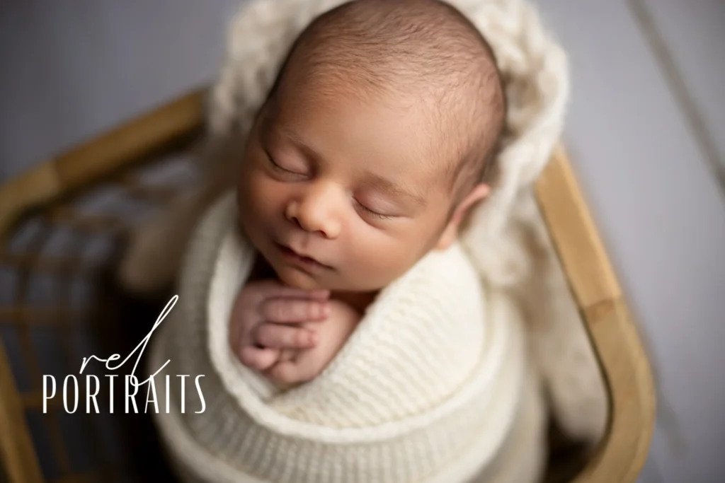 Newborn baby boy in cream