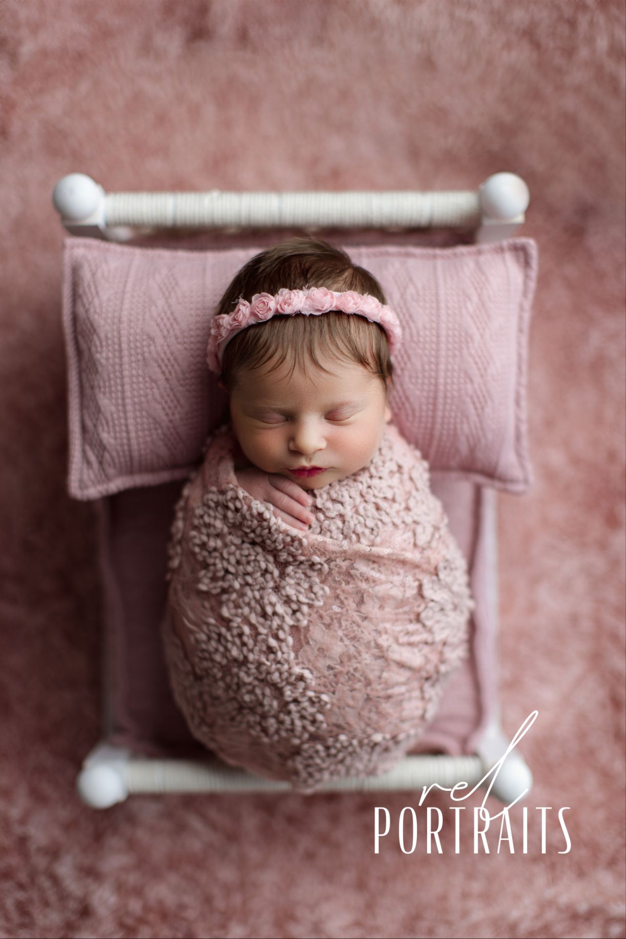 beautiful baby girl posed in a bed